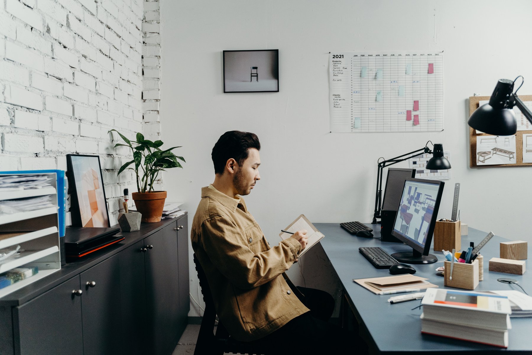 Woman in Brown Coat Sitting on Black Office Rolling Chair